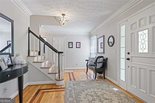 7045 Hunters Knl NE, Sandy Springs, GA 30328 - foyer entrance with stairway, wood finished floors, a textured ceiling, a chandelier, and ornamental molding