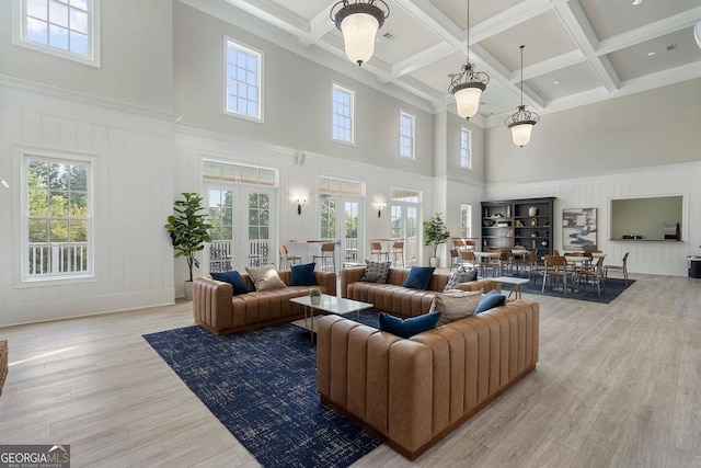 6430 Banbury Ct SE, Mableton, GA 30126 - living room featuring a high ceiling, beamed ceiling, plenty of natural light, a decorative wall, and wood finished floors