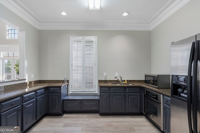 6430 Banbury Ct SE, Mableton, GA 30126 - kitchen with appliances with stainless steel finishes, ornamental molding, dark stone counters, light wood-type flooring, and recessed lighting