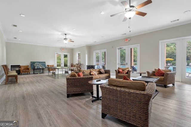 6430 Banbury Ct SE, Mableton, GA 30126 - living room with ceiling fan, recessed lighting, crown molding, light wood-style floors, and french doors
