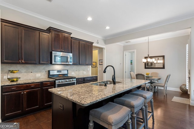6430 Banbury Ct SE, Mableton, GA 30126 - kitchen featuring stainless steel appliances, a chandelier, a kitchen bar, light stone counters, and recessed lighting