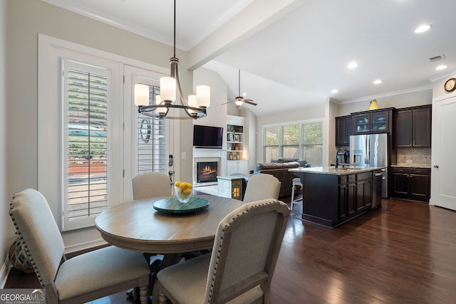 6430 Banbury Ct SE, Mableton, GA 30126 - dining space featuring a chandelier, dark wood-style floors, a lit fireplace, recessed lighting, and ornamental molding