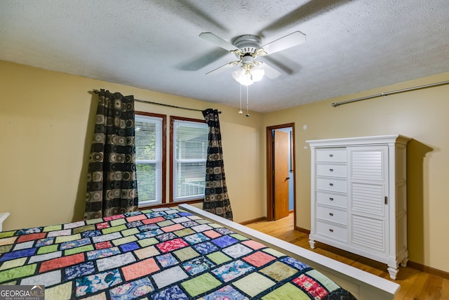 220 Gamble Dr, Carrollton, GA 30116 - bedroom with wood finished floors, a textured ceiling, and a ceiling fan