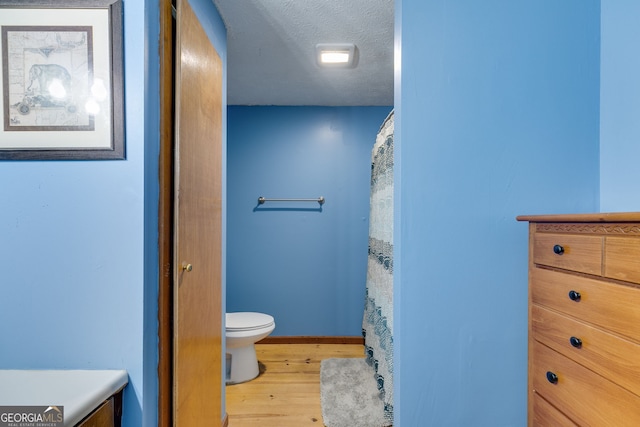 220 Gamble Dr, Carrollton, GA 30116 - bathroom featuring wood finished floors and a textured ceiling