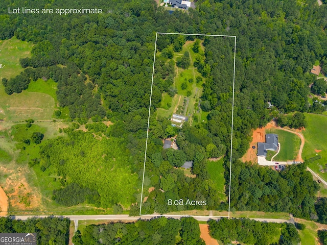 220 Gamble Dr, Carrollton, GA 30116 - aerial view of property and surrounding area featuring a heavily wooded area and property parcel outlined