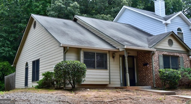 1106 Shiloh Ln NW, Kennesaw, GA 30144 - view of front facade featuring a chimney, roof with shingles, and brick siding