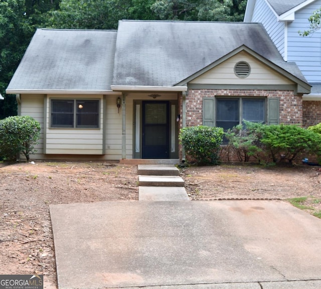 1106 Shiloh Ln NW, Kennesaw, GA 30144 - view of front facade featuring brick siding and roof with shingles