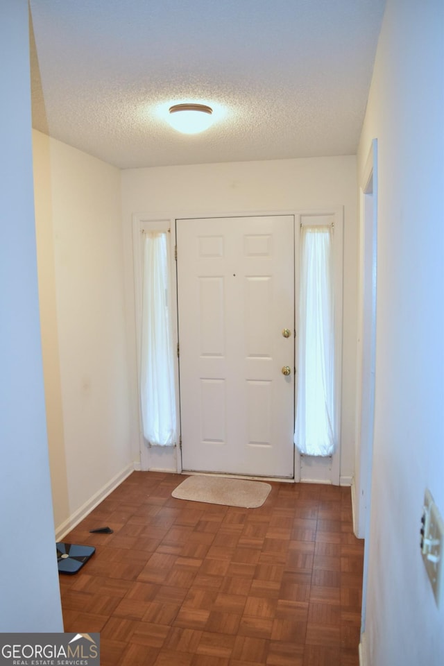 1106 Shiloh Ln NW, Kennesaw, GA 30144 - foyer entrance featuring a textured ceiling and baseboards