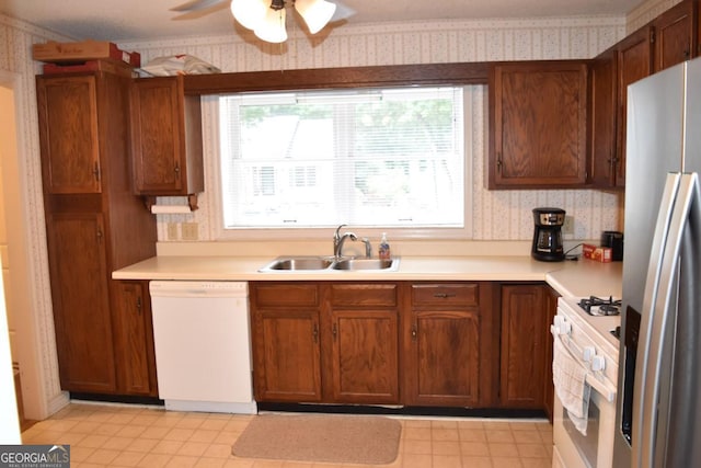 1106 Shiloh Ln NW, Kennesaw, GA 30144 - kitchen featuring white appliances, wallpapered walls, light countertops, ceiling fan, and brown cabinetry