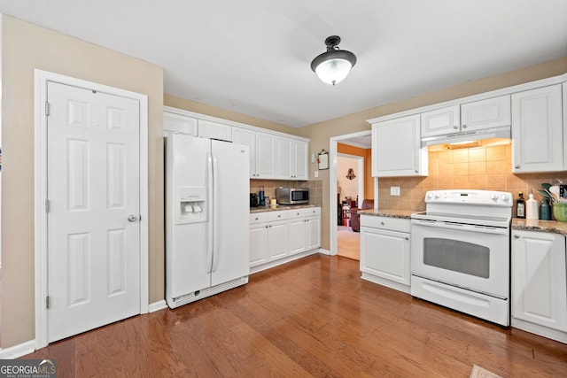 5340 Harris Creek Dr, Cumming, GA 30040 - kitchen with white appliances, under cabinet range hood, tasteful backsplash, and white cabinetry