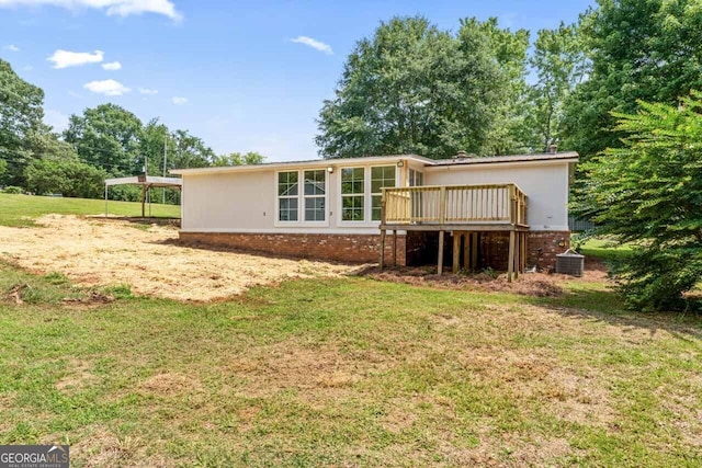 166 James Dr, Hampton, GA 30228 - rear view of house with a wooden deck, brick siding, and a lawn