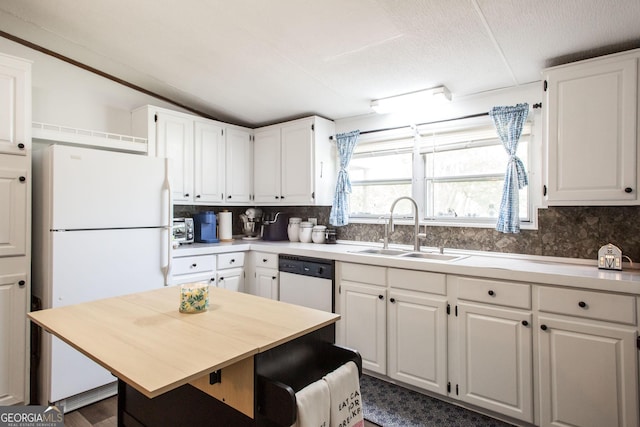 3564 Chapel Cir, Blackshear, GA 31516 - kitchen featuring white appliances, decorative backsplash, white cabinets, and vaulted ceiling