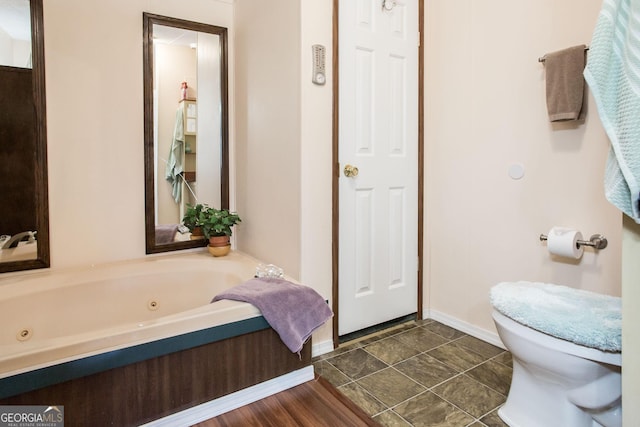 3564 Chapel Cir, Blackshear, GA 31516 - bathroom featuring a whirlpool tub and toilet