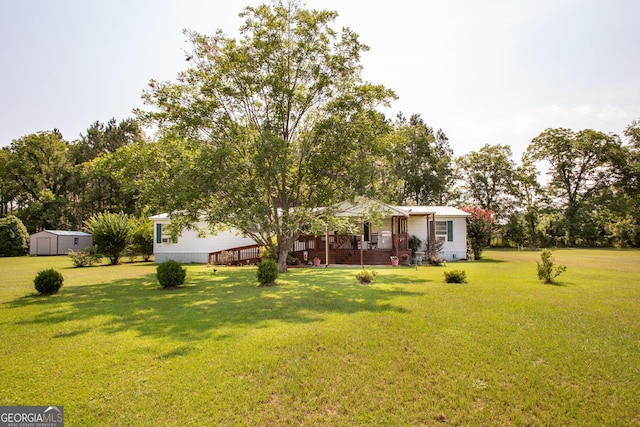 3564 Chapel Cir, Blackshear, GA 31516 - view of front facade with a storage shed, a front lawn, and covered porch