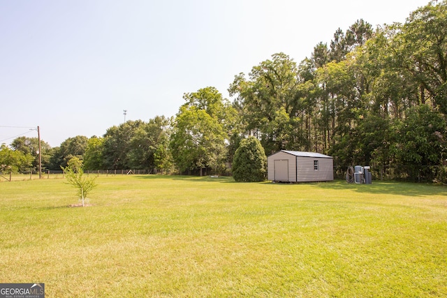 3564 Chapel Cir, Blackshear, GA 31516 - view of green lawn with a storage shed and view of wooded area