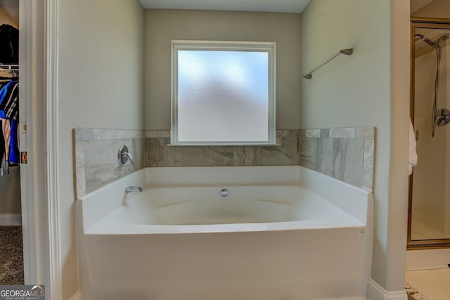 116 Sophie Cir, Locust Grove, GA 30248 - full bathroom featuring a spacious closet and a garden tub