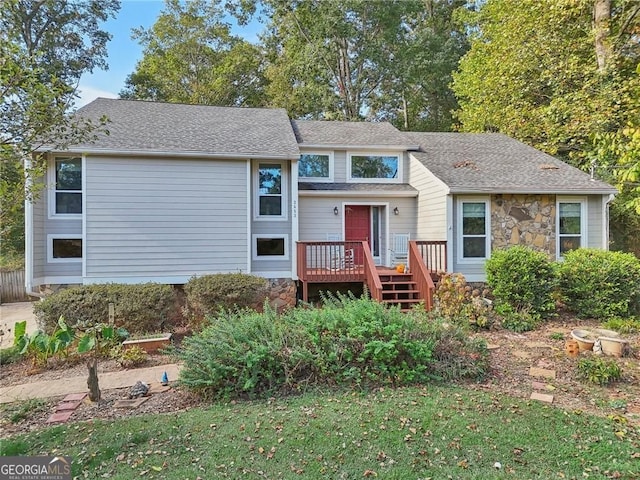2653 Partridge Trl, Duluth, GA 30097 - view of front of home featuring a deck, stone siding, and roof with shingles
