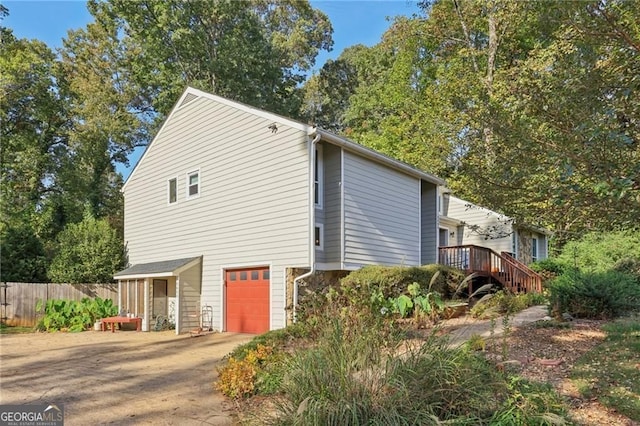 2653 Partridge Trl, Duluth, GA 30097 - view of side of home featuring an attached garage, driveway, and stairs