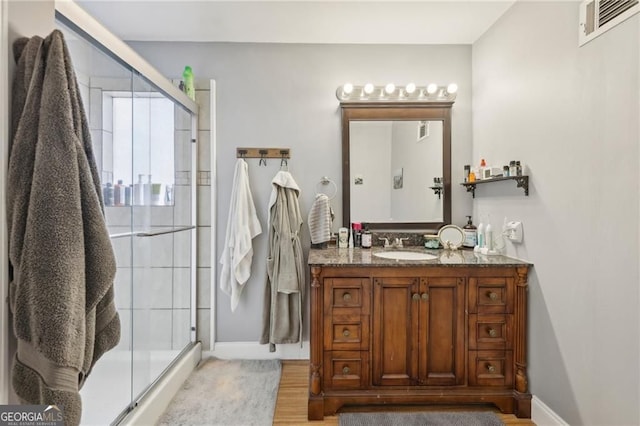 2653 Partridge Trl, Duluth, GA 30097 - bathroom with vanity, a shower stall, and wood finished floors