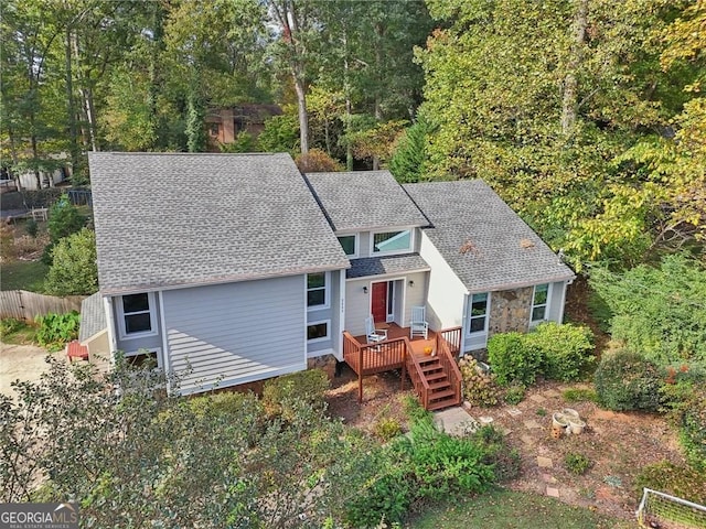 2653 Partridge Trl, Duluth, GA 30097 - view of front of house with a wooden deck, roof with shingles, and stone siding