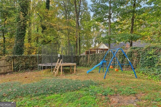 2653 Partridge Trl, Duluth, GA 30097 - view of jungle gym with a trampoline and a fenced backyard