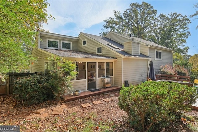2653 Partridge Trl, Duluth, GA 30097 - rear view of house featuring a sunroom and roof with shingles
