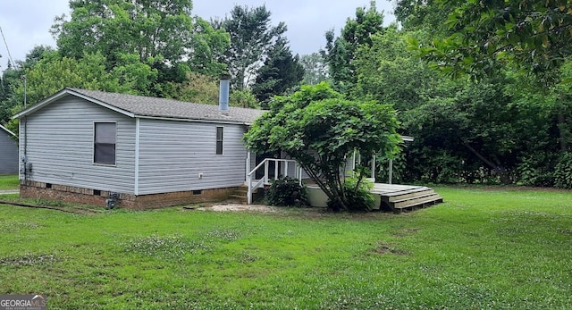 201 Rogers St, Mcdonough, GA 30253 - rear view of property featuring crawl space, a wooden deck, a yard, and roof with shingles