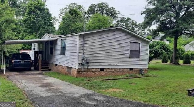 201 Rogers St, Mcdonough, GA 30253 - view of home's exterior with crawl space, a lawn, an attached carport, and driveway