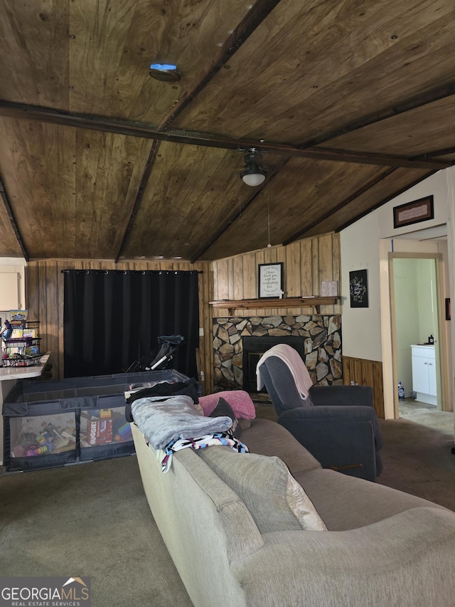 201 Rogers St, Mcdonough, GA 30253 - carpeted living room featuring wood ceiling, wooden walls, a stone fireplace, and a wainscoted wall