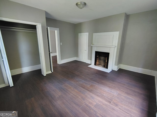 501 Calhoun Ave NE, Rome, GA 30161 - unfurnished living room with a fireplace and dark wood finished floors