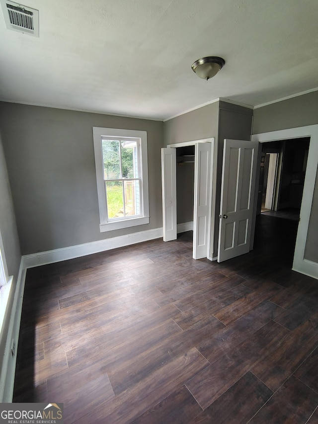 501 Calhoun Ave NE, Rome, GA 30161 - unfurnished bedroom with dark wood finished floors, a closet, and ornamental molding