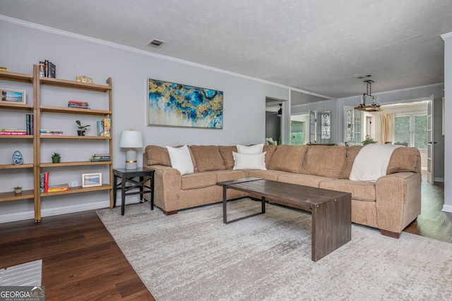 9 Saint Claire Ln NE, Atlanta, GA 30324 - living room with wood finished floors, crown molding, and a textured ceiling