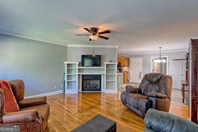 104 View St, Clarkesville, GA 30523 - living area featuring a ceiling fan, a chandelier, light wood-type flooring, ornamental molding, and a fireplace