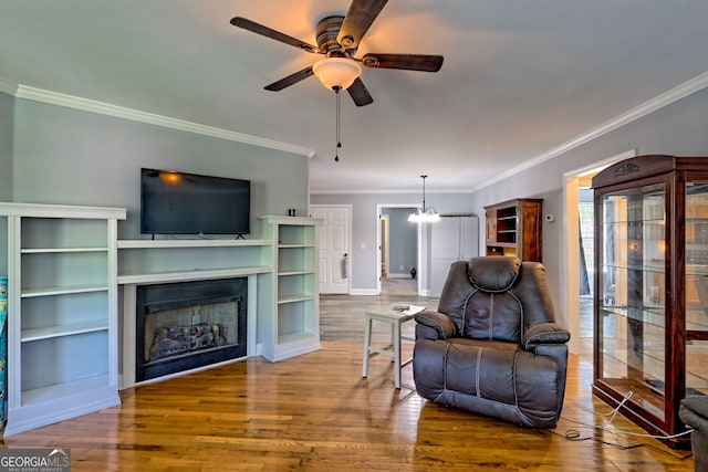 104 View St, Clarkesville, GA 30523 - living area featuring ornamental molding, a ceiling fan, wood finished floors, a fireplace, and a chandelier