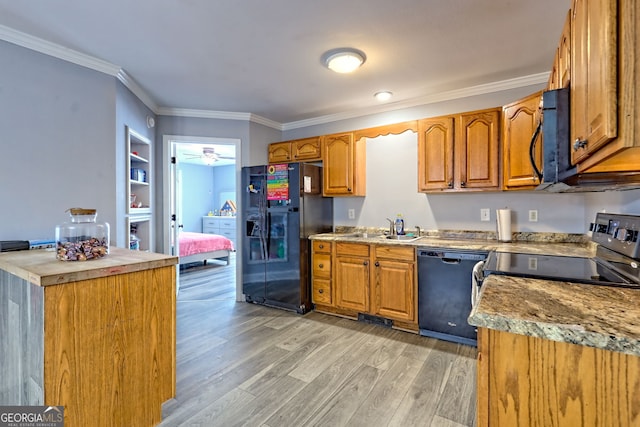 104 View St, Clarkesville, GA 30523 - kitchen with black appliances, light wood finished floors, ornamental molding, brown cabinetry, and ceiling fan