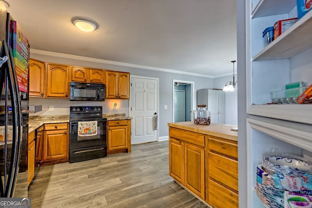 104 View St, Clarkesville, GA 30523 - kitchen with black appliances, crown molding, brown cabinetry, and light wood-style floors