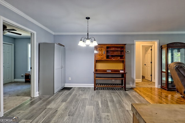 104 View St, Clarkesville, GA 30523 - dining room with wood finished floors, crown molding, a chandelier, and a ceiling fan