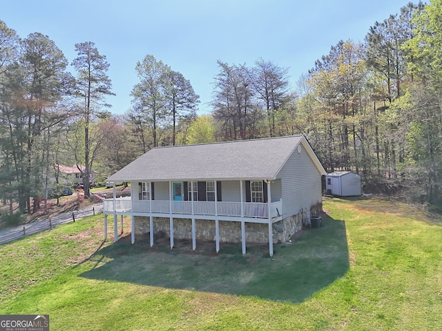 104 View St, Clarkesville, GA 30523 - view of front facade featuring covered porch, a storage shed, and a shingled roof