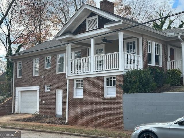 1134 Donnelly Ave SW, Atlanta, GA 30310 - view of side of property featuring an attached garage, a chimney, brick siding, a balcony, and a ceiling fan