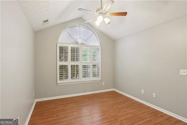 3707 Vineyards Lake Cir NW Unit 22, Kennesaw, GA 30144 - spare room featuring ceiling fan, vaulted ceiling, and wood finished floors