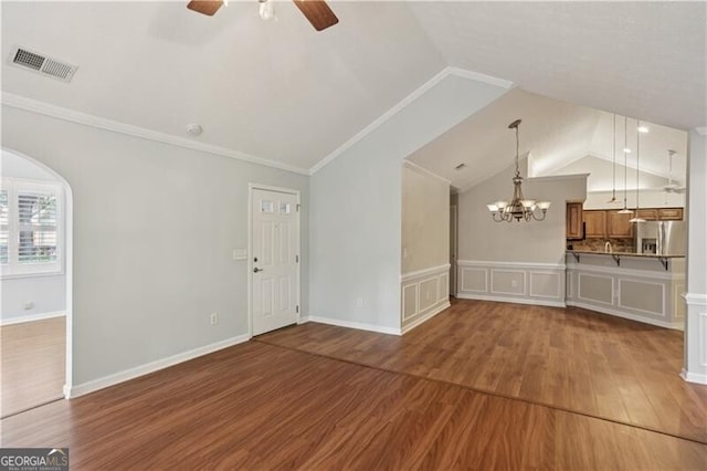 3707 Vineyards Lake Cir NW Unit 22, Kennesaw, GA 30144 - unfurnished living room featuring wood finished floors, lofted ceiling, a ceiling fan, arched walkways, and crown molding