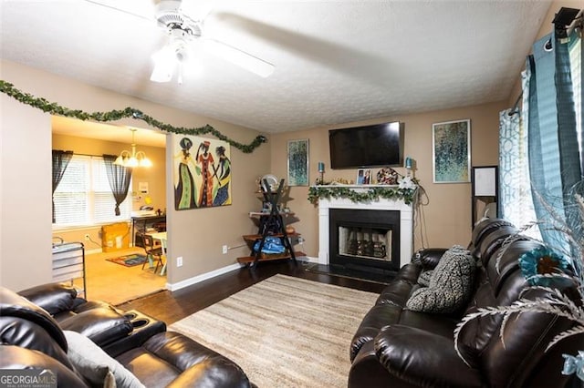 1643 Trey Ln, Winder, GA 30680 - living area with wood finished floors, a ceiling fan, a fireplace, and a chandelier