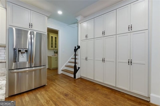 360 Hannaford Dr, Roswell, GA 30075 - kitchen with stainless steel fridge with ice dispenser, light wood-style floors, white cabinetry, light stone counters, and recessed lighting