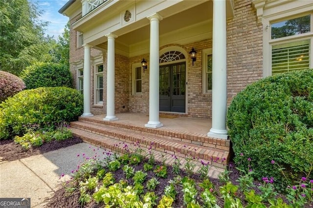 360 Hannaford Dr, Roswell, GA 30075 - doorway to property featuring a porch and brick siding