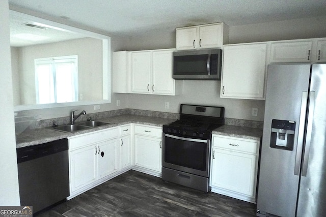 5761 Antelope Trl, Atlanta, GA 30349 - kitchen featuring stainless steel appliances, white cabinetry, dark wood-style floors, and light countertops