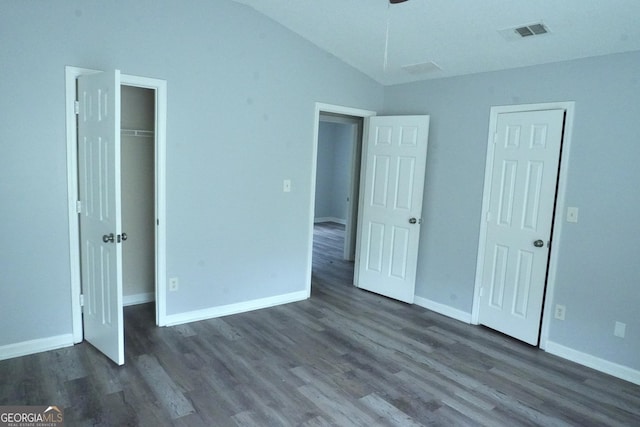 5761 Antelope Trl, Atlanta, GA 30349 - unfurnished bedroom featuring vaulted ceiling, dark wood finished floors, and a closet