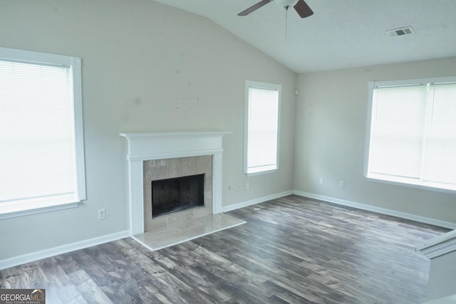 5761 Antelope Trl, Atlanta, GA 30349 - unfurnished living room with a ceiling fan, vaulted ceiling, wood finished floors, and a tile fireplace