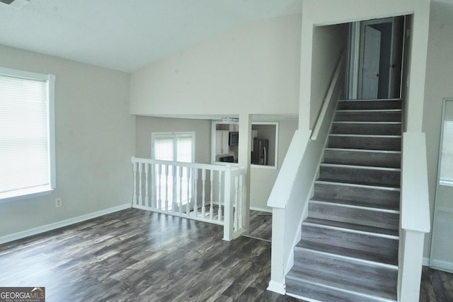 5761 Antelope Trl, Atlanta, GA 30349 - staircase featuring vaulted ceiling and wood finished floors