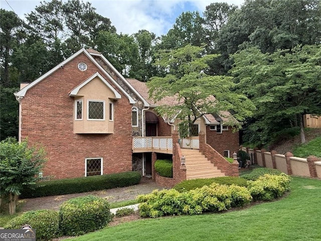 4027 Wood Acres Ct, Duluth, GA 30096 - back of property with brick siding, a wooden deck, a yard, and stairs
