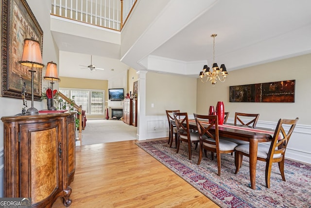 25 Hampreston Ct, Alpharetta, GA 30022 - dining room with wood finished floors, decorative columns, a chandelier, a decorative wall, and wainscoting
